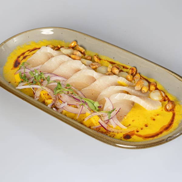 Bocas House's Latin American ceviche with white fish, red onions, corn, and yellow sauce.