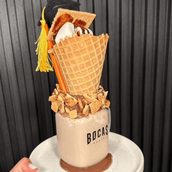 Bocas House milkshake in a jar, topped with a waffle cone, ice cream, and a graduation cap.