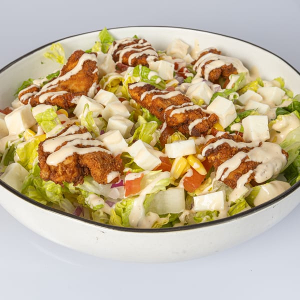 Bocas House salad with fried chicken, cheese cubes, corn, tomatoes, and creamy dressing.