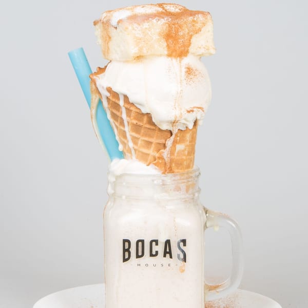 Bocas House milkshake in a mason jar, topped with a waffle cone, ice cream, and cinnamon.